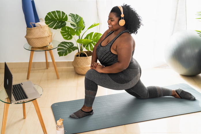 Curvy Woman Doing Pilates in Virtual Fitness Class 