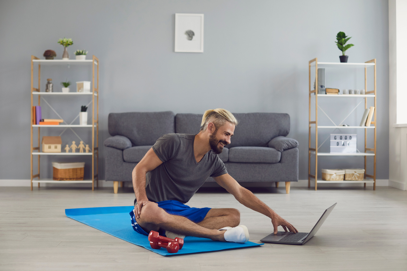 Workout Exercise Fitness Online Video Call. Man Doing Exercises of an Online Fitness Course Training in a Laptop Video Chat at Home.